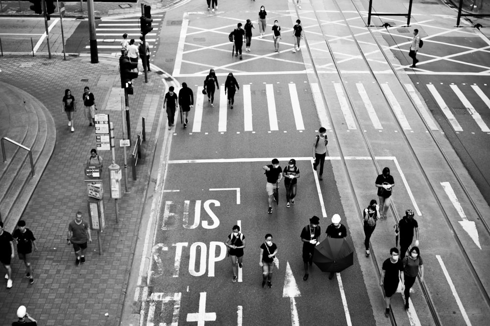 grayscale photo of people crossing road
