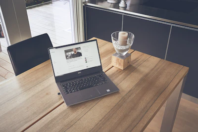 A peaceful workspace with crystals, candles, and a laptop showing lolohealth exercises.