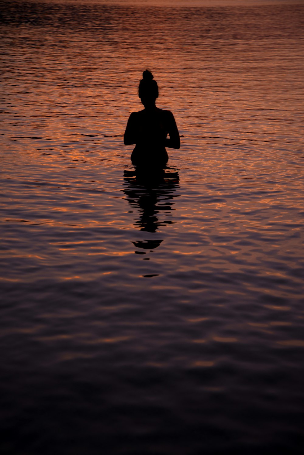 silhouette of person on sea]