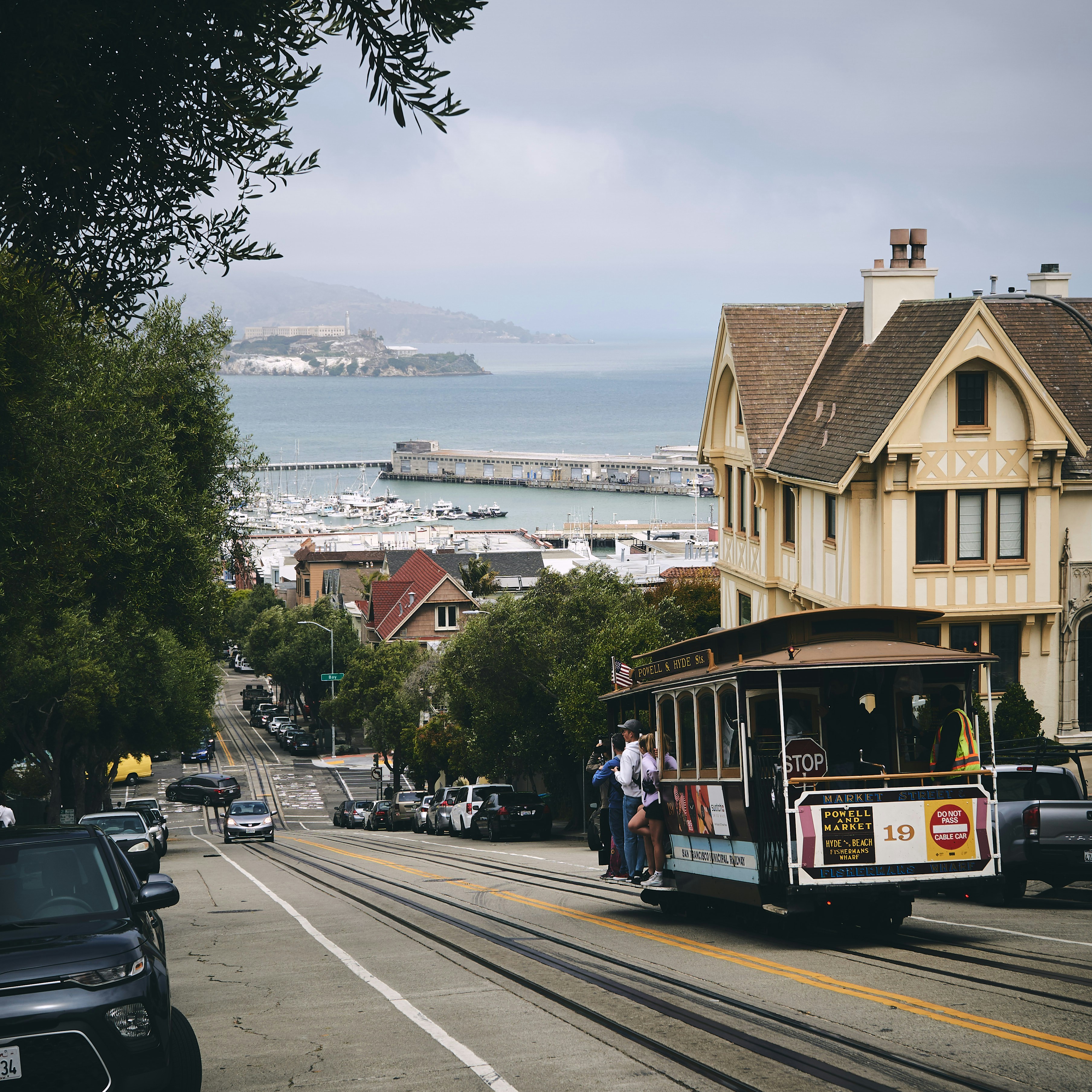 train between building and tree