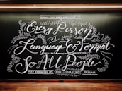 Intricate chalkboard art with elaborate, cursive text and decorative floral elements. The design emphasizes accessibility of messages across languages and formats.