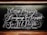 Intricate chalkboard art with elaborate, cursive text and decorative floral elements. The design emphasizes accessibility of messages across languages and formats.