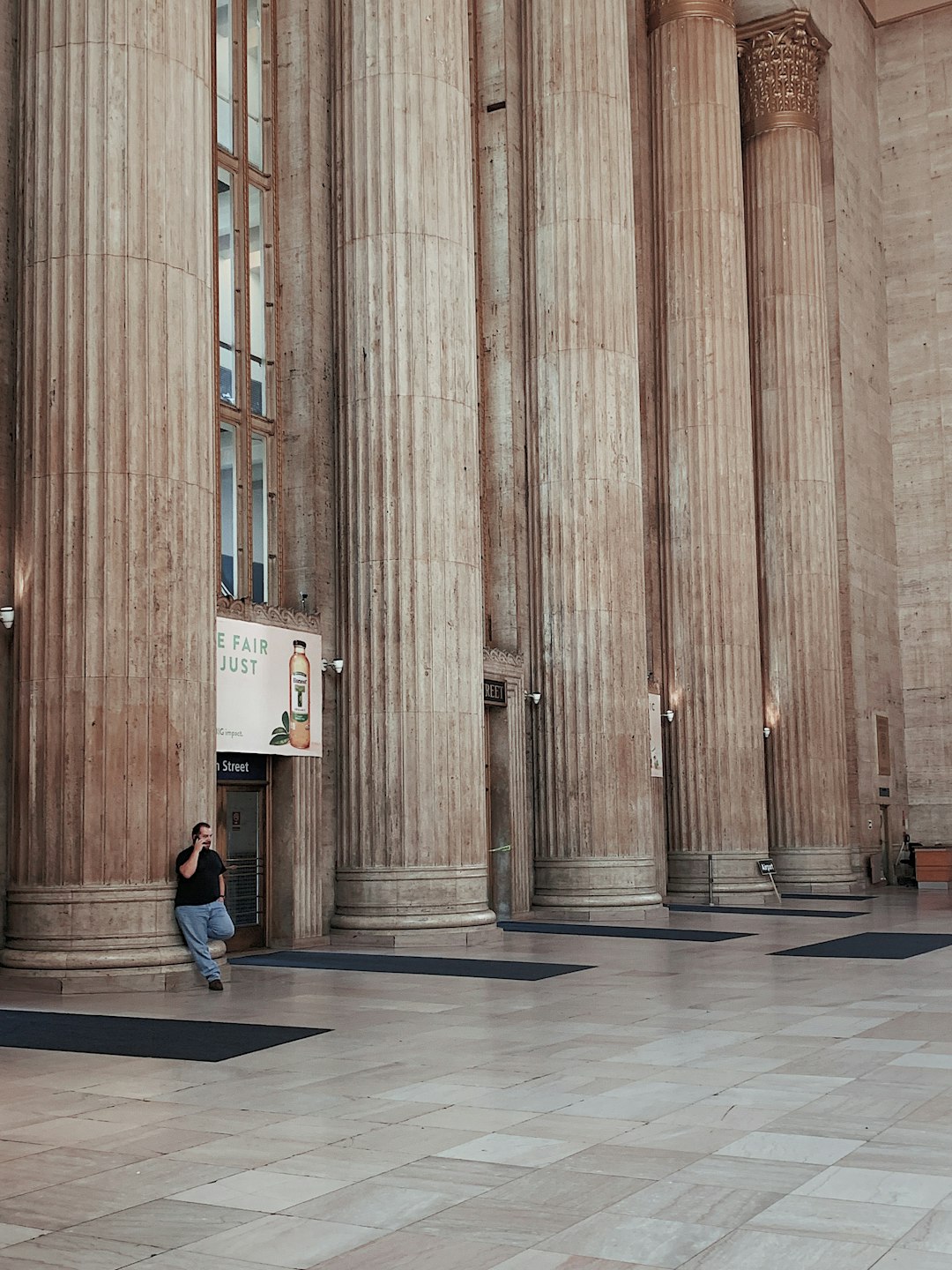 man leaning beside wall