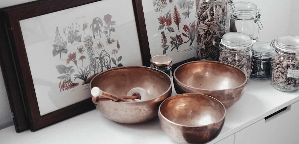 stainless steel bowls on table near framed photos