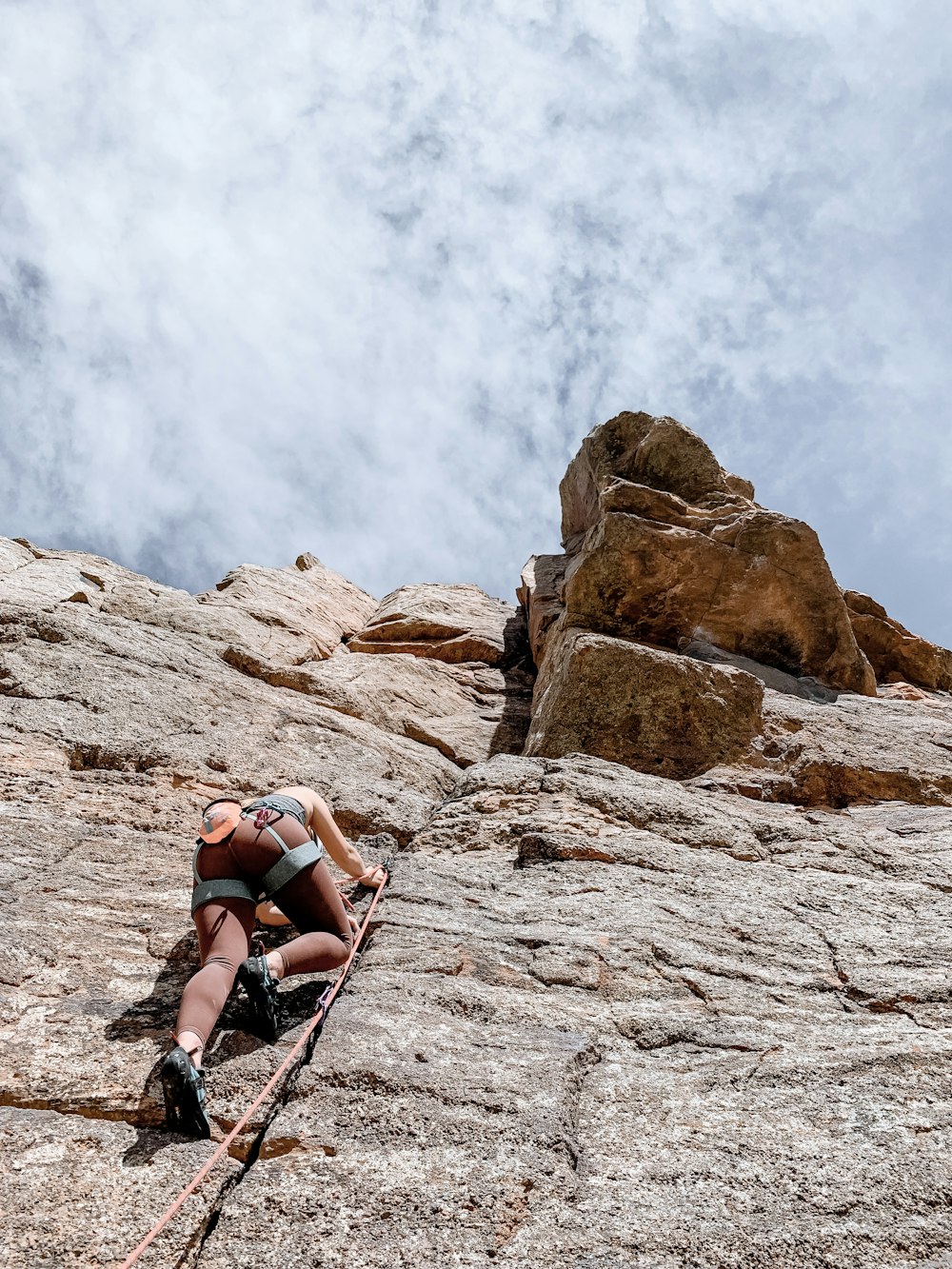 a man climbing up the side of a mountain