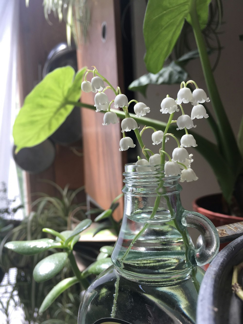 a glass vase filled with white flowers on top of a table