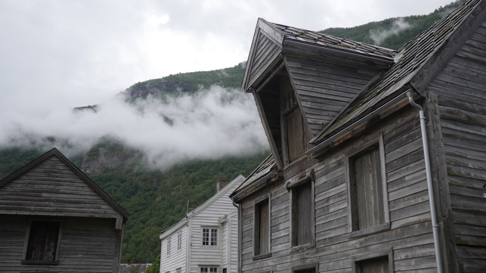 a row of wooden buildings with a mountain in the background
