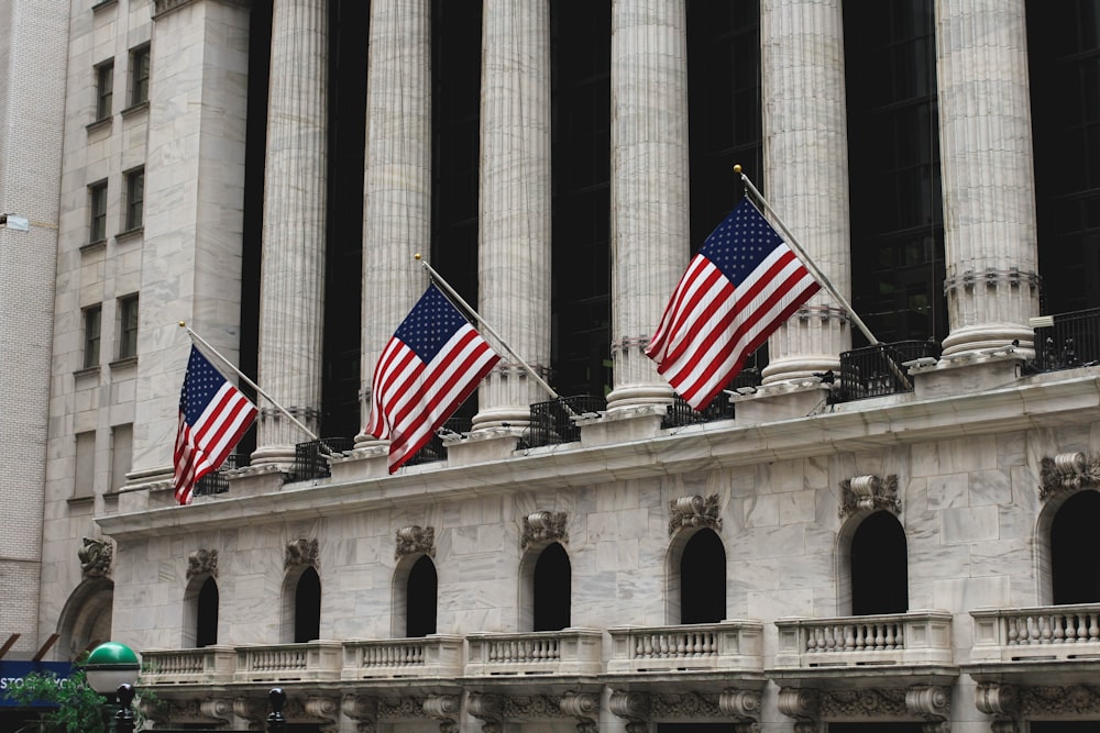 three flag of America on concrete building during daytime