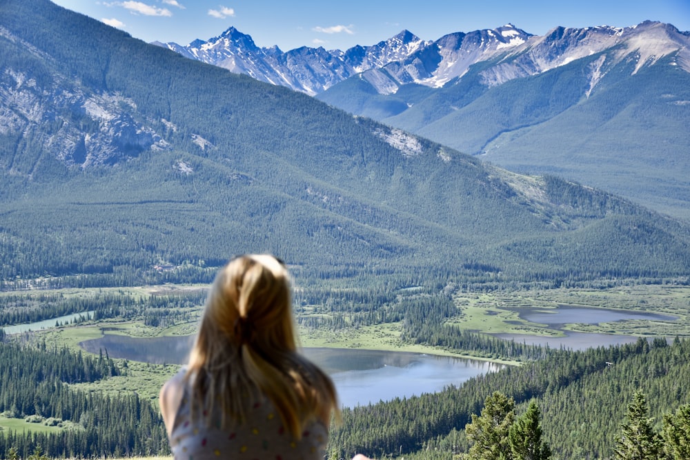 woman looking on green and white mountain view