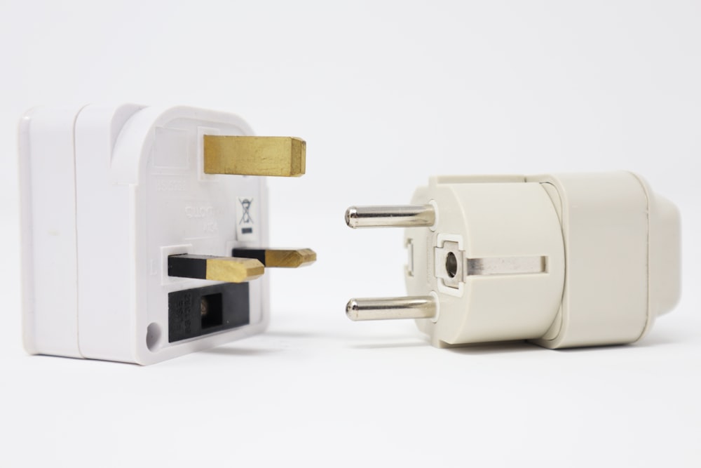 two white power adapters on white background