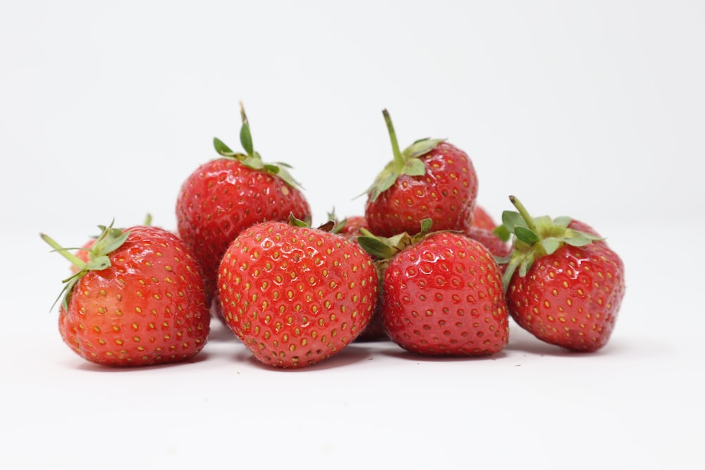 bunch of strawberries in white surface