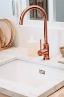 square white sink with brass faucet