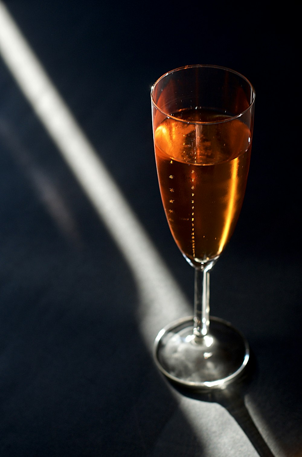 a glass filled with liquid sitting on top of a table