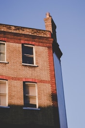 Photo of a newly built brick house showcasing quality masonry work under bright daylight.