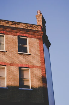 A charming brick townhouse in Greater Manchester bathed in warm afternoon light.