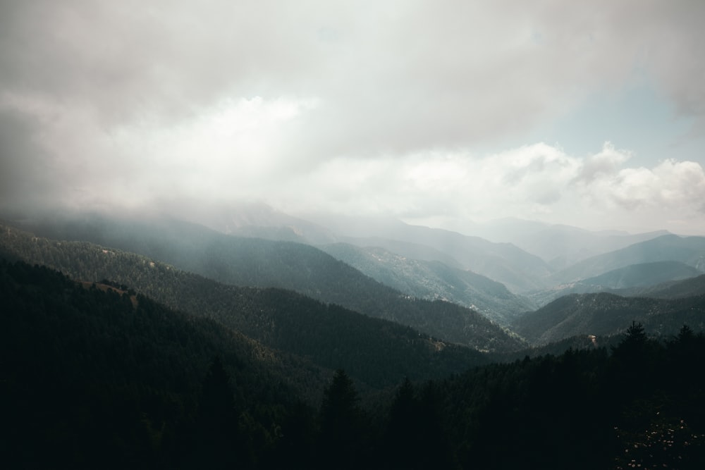 mountain range under cloudy sky