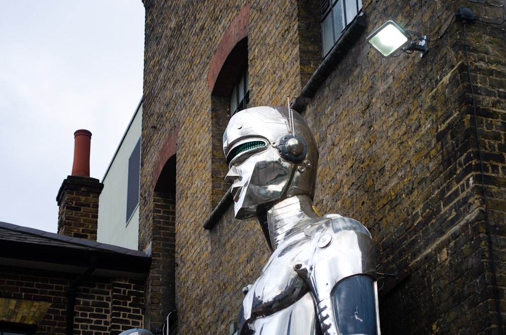 gray concrete statue beside concrete building