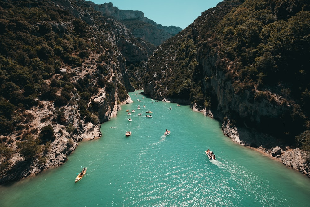 a group of people riding paddle boats on a river