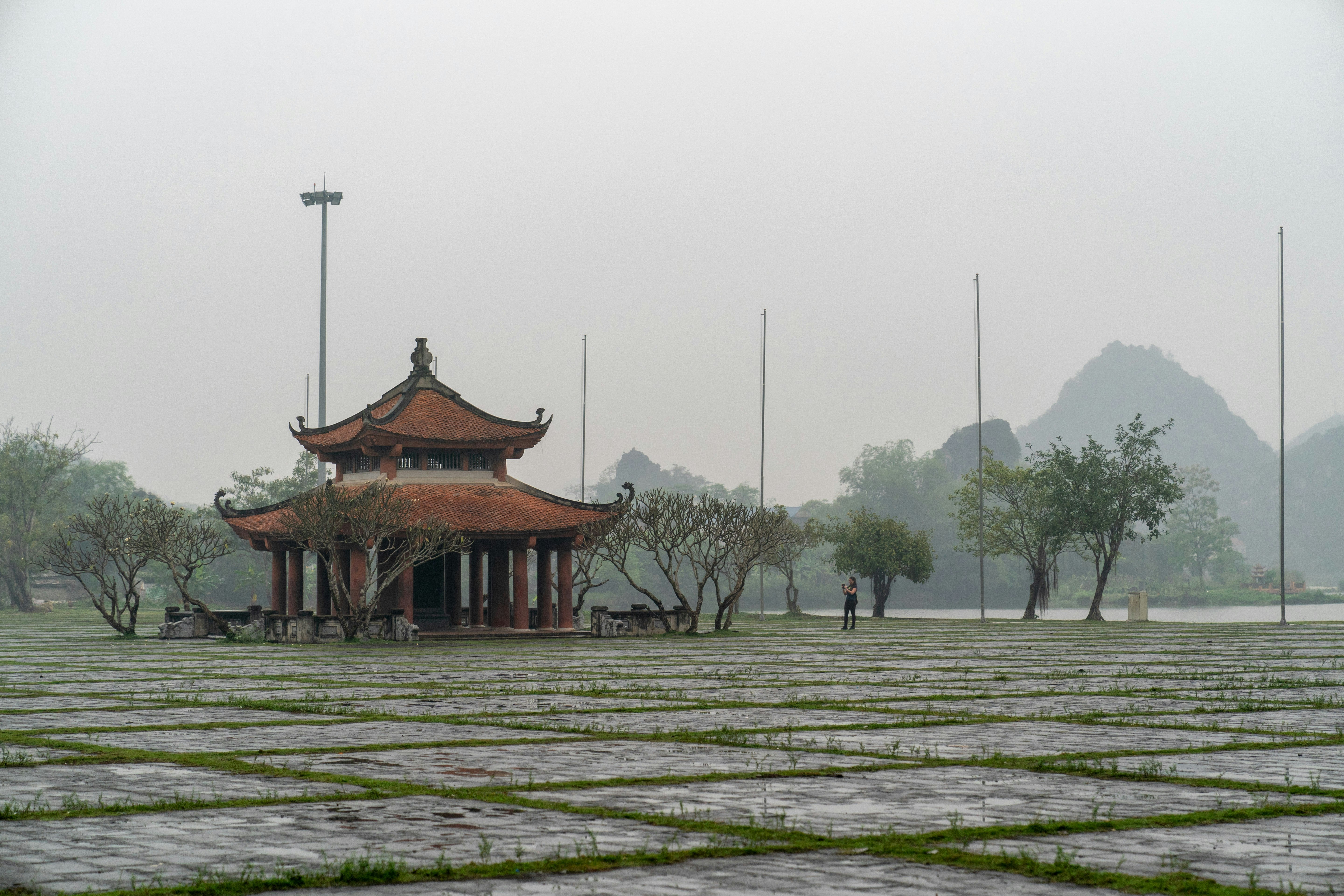 a small pavilion in the middle of a park, A temple in the mist