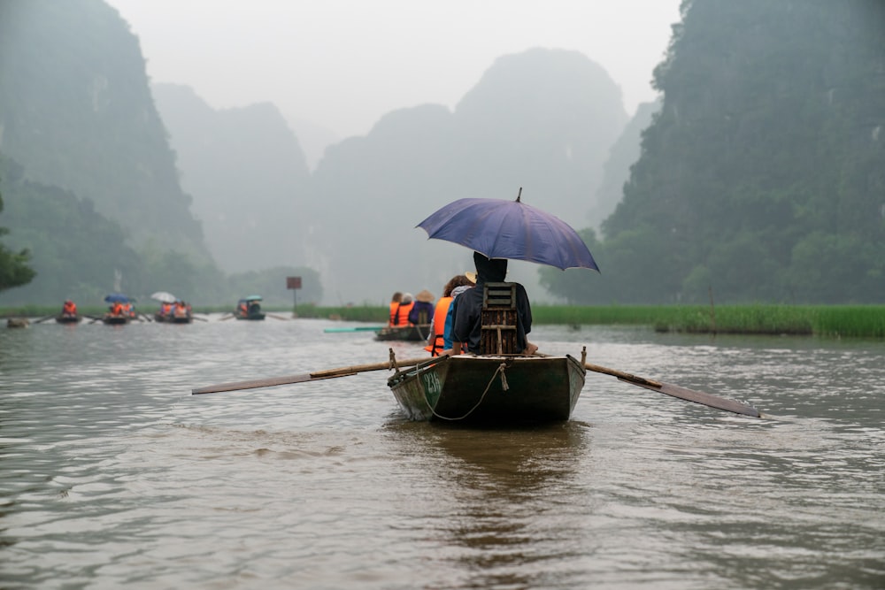 person riding on boat om water