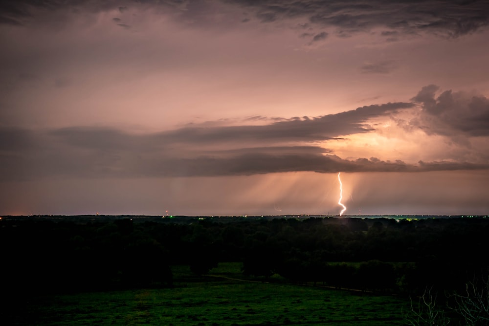 a lightning bolt in the sky over a field