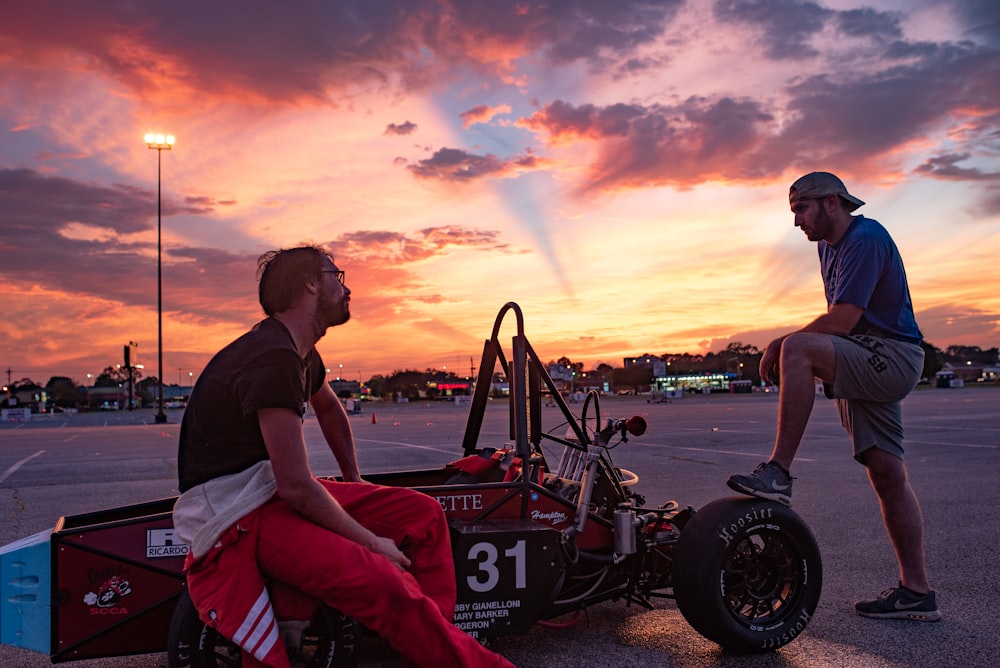 two person near a racing cart during daytime