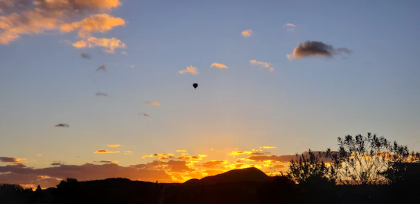 Sunset scene with a hot air balloon drifting gently in the sky