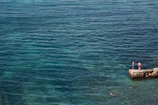 A group of swimmers enjoying a leisurely swim near the platform with easy sea access.