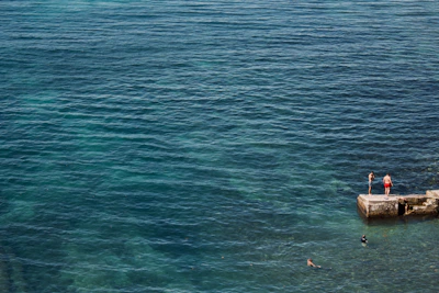 A group of swimmers enjoying a leisurely swim near the platform with easy sea access.