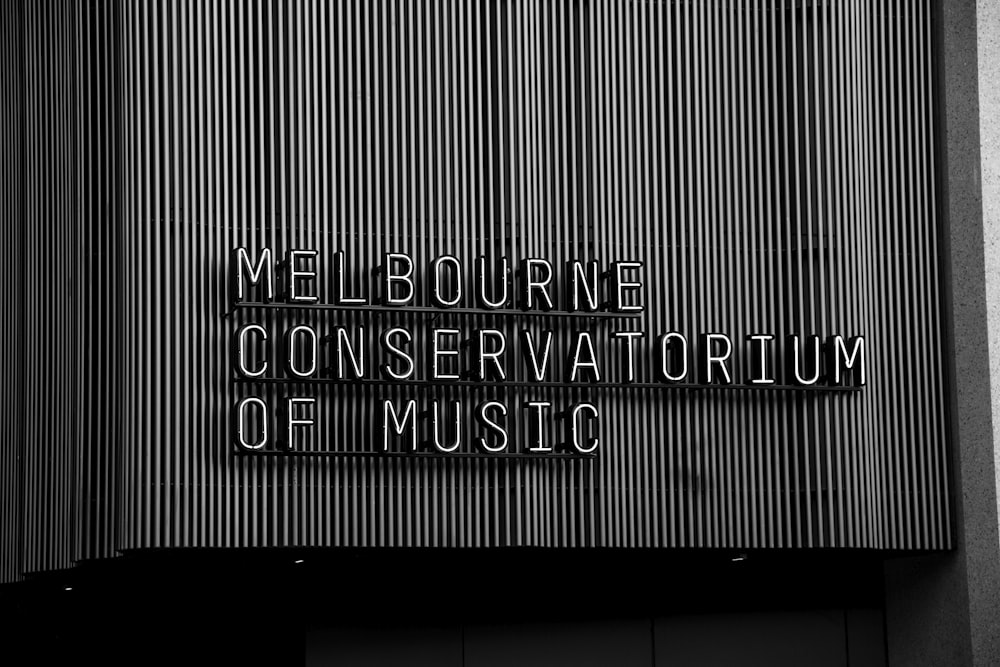 a black and white photo of a sign on a building