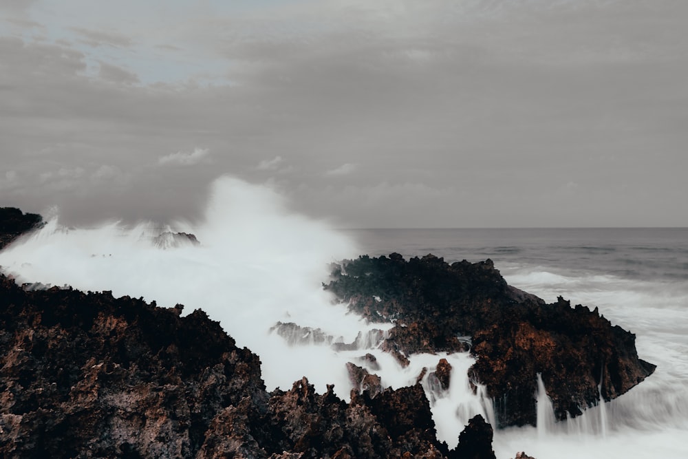 ocean waves crashing on stones