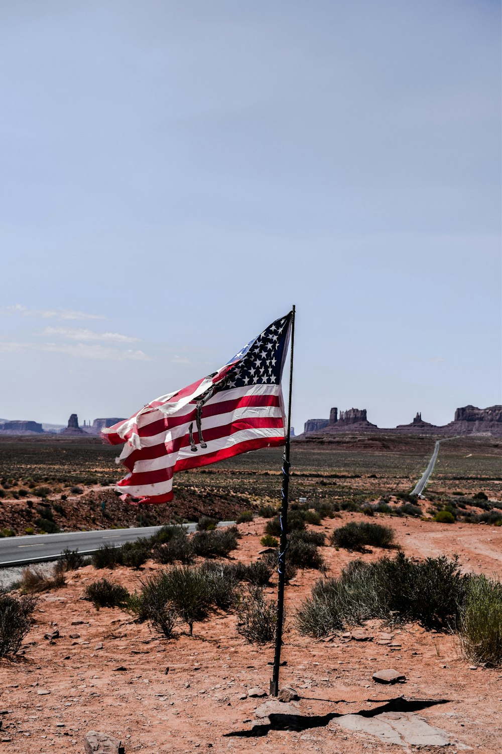 USA flag near grey concrete road