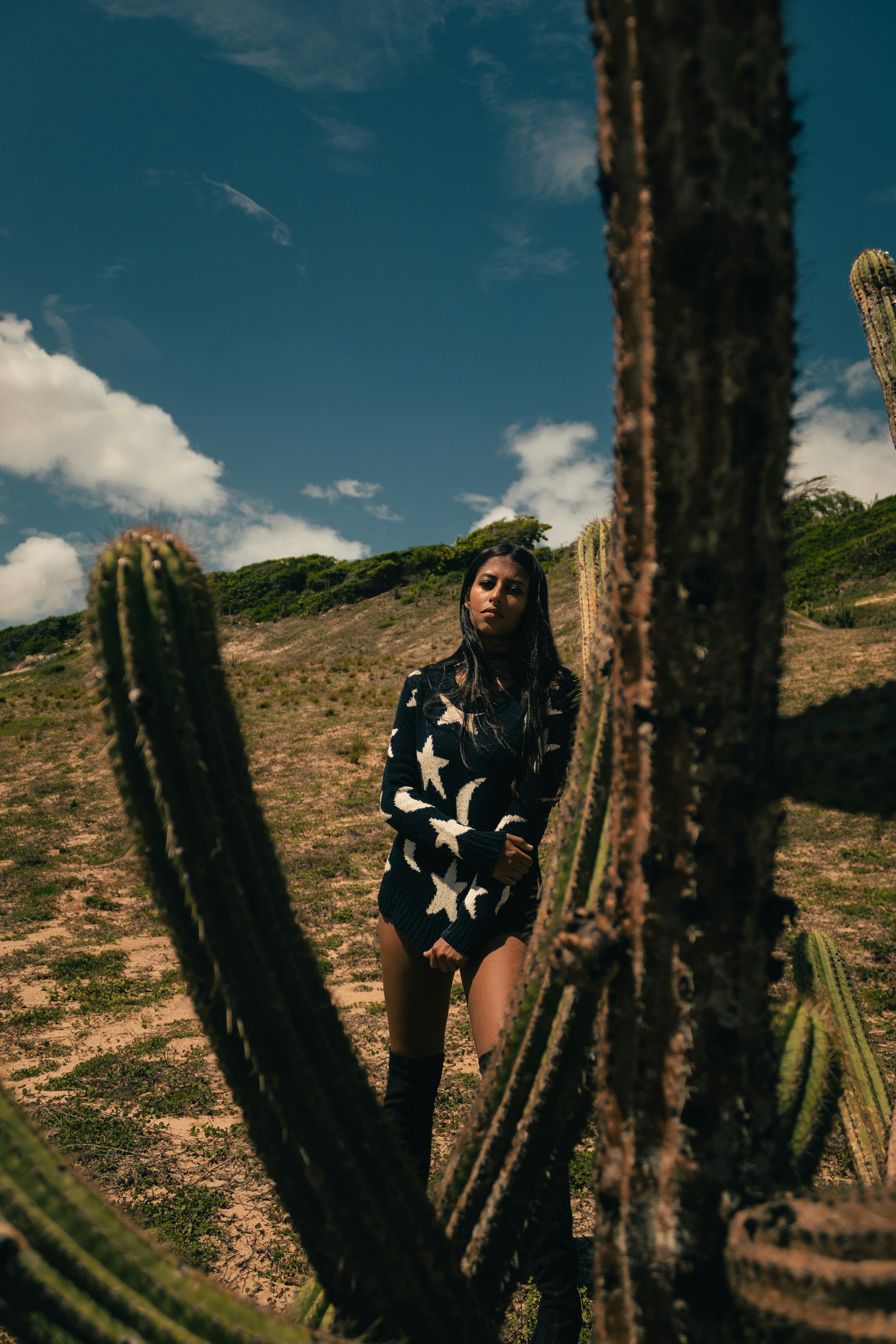 woman standing beside cactus