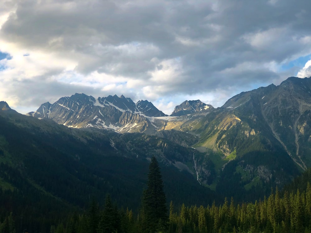 mountain range under nimbus cloud s