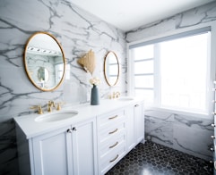 a bathroom with two sinks and a large mirror