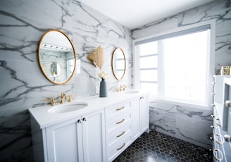 a bathroom with two sinks and a large mirror