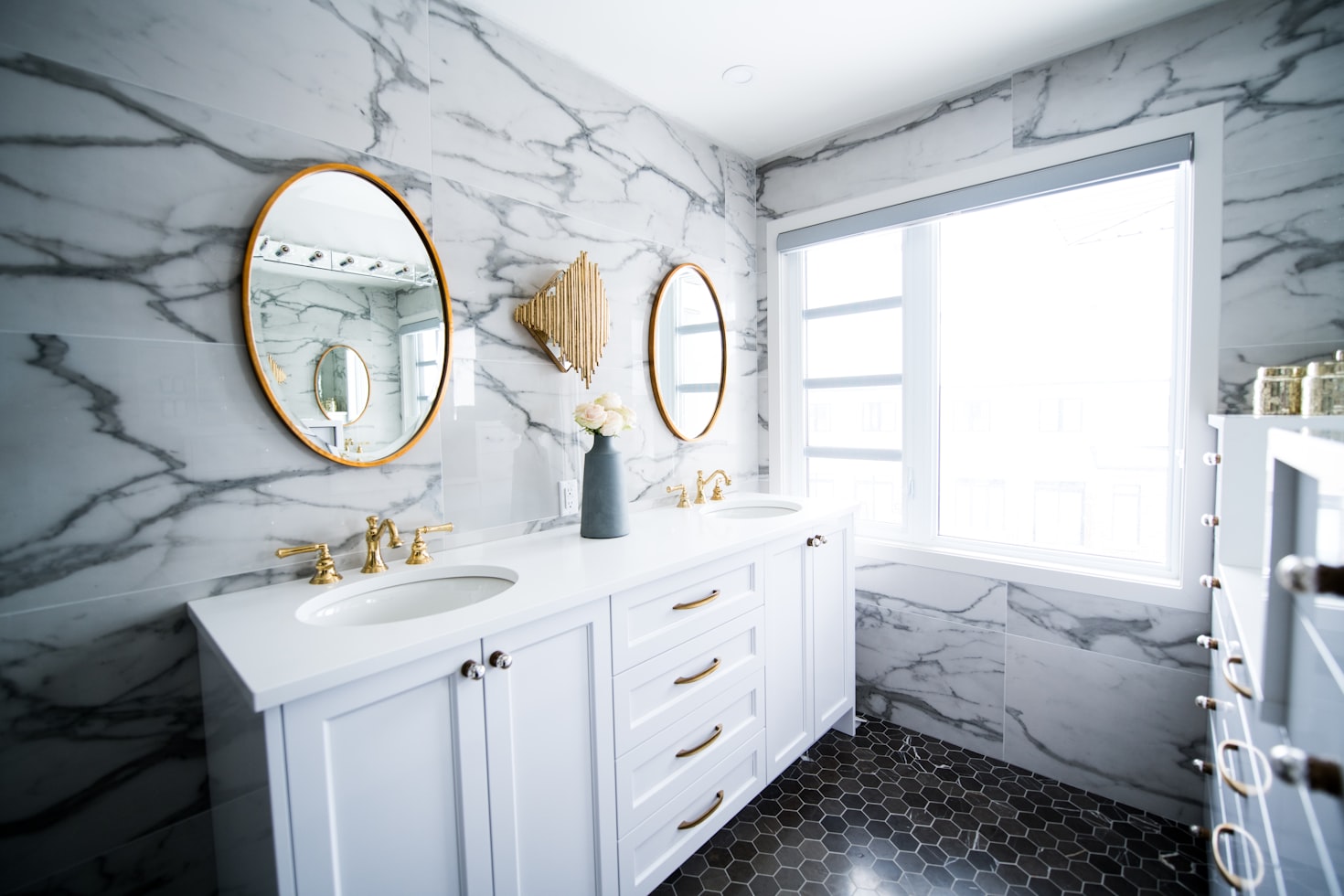 Modern white granite bathroom with gold fixtures