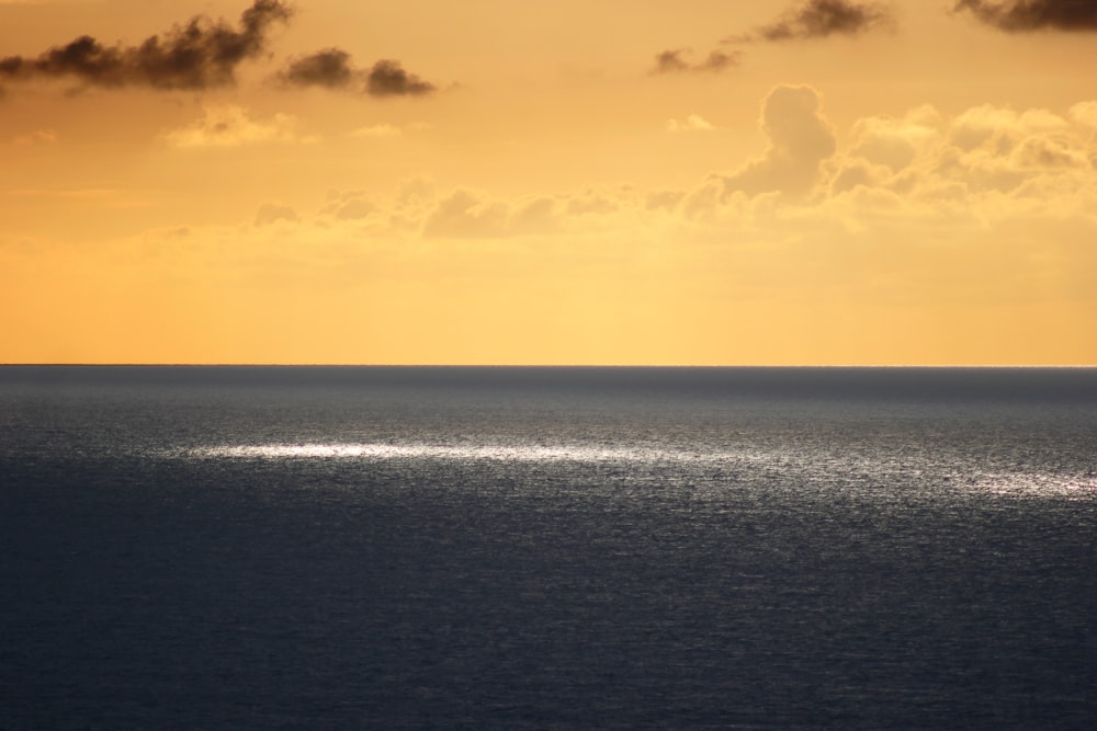 gray sea under orange skies