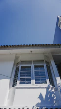 Skilled technicians installing a sleek UPVC window on a modern home exterior.