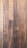 Dark wooden planks with visible grain patterns and some knots create a rustic and textured surface. The wood has various shades of brown, ranging from light to dark tones, adding depth and character.