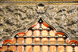 Close-up of a glowing plasma-cut metal wall piece with detailed floral patterns.