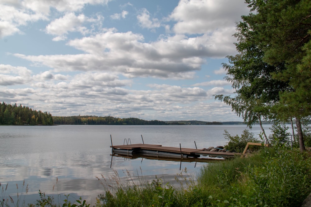 brown wooden platform at the lake under grey cloudy sky