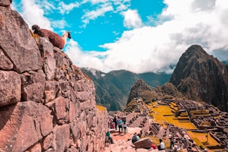 people near Machu Picchu under blue and white skies