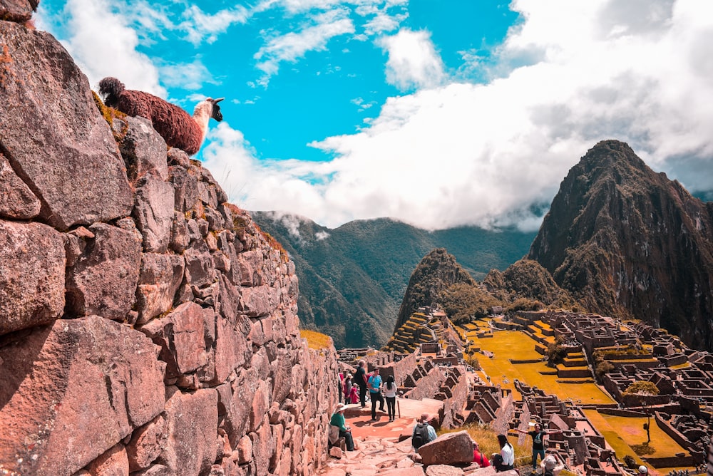 gente cerca de Machu Picchu bajo cielos azules y blancos