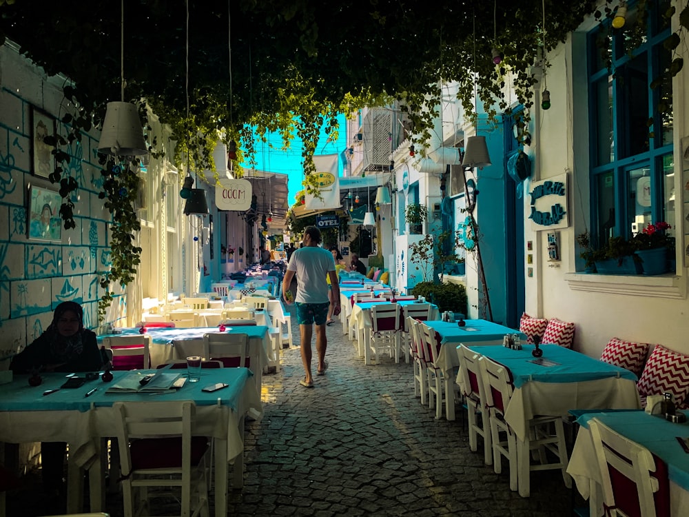 man walking in between dining tables