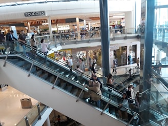 An escalator in a busy shopping mall.