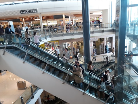 An escalator in a busy shopping mall.