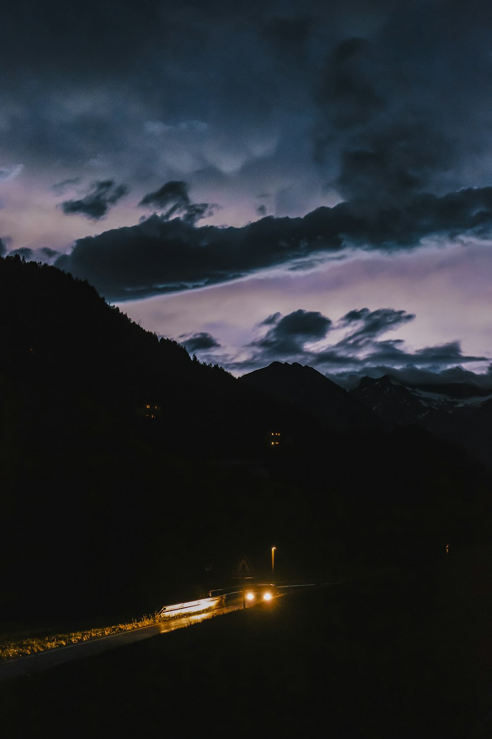 silhouette photography of mountain under cloudy sky