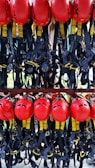 A collection of bright red helmets and black harnesses with yellow accents are neatly organized and hanging on a rack. They are likely used for safety in activities such as climbing or construction.
