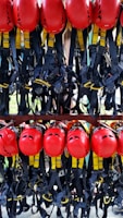 A collection of safety equipment including helmets, gloves, and goggles on a workbench.